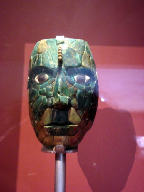 A replica of Pakal's death mask. When it was found, the cloth backing that held the pieces of jade together had disintegrated, and scientists painstakingly put them back together to form this image.
