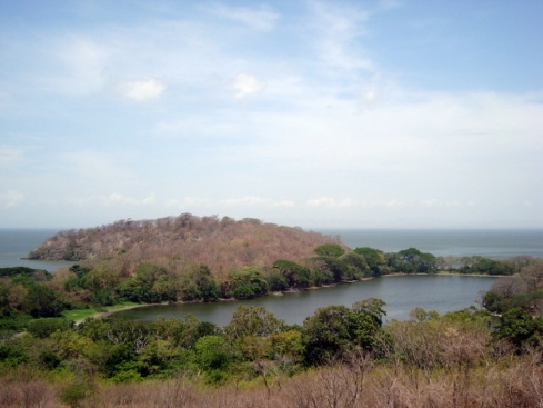 A view of the Chaco Verde, a small lake, from above. Behind it is an island. 