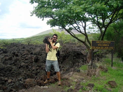 Rick cut his hands on this piece of ancient lava. Behind him is an ancient lava flow.