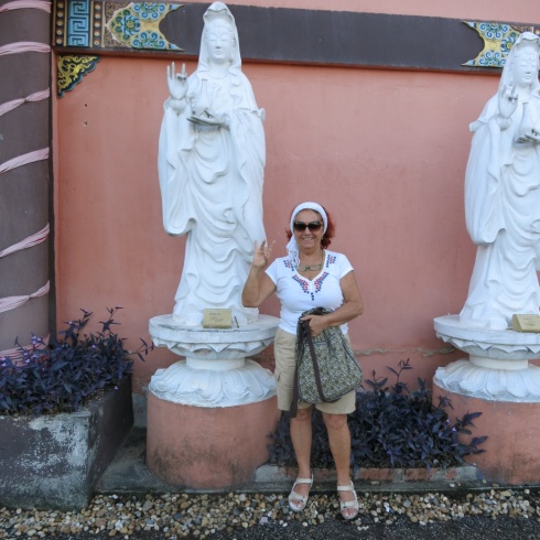 Eva, next to a statue of Kuan Yin.